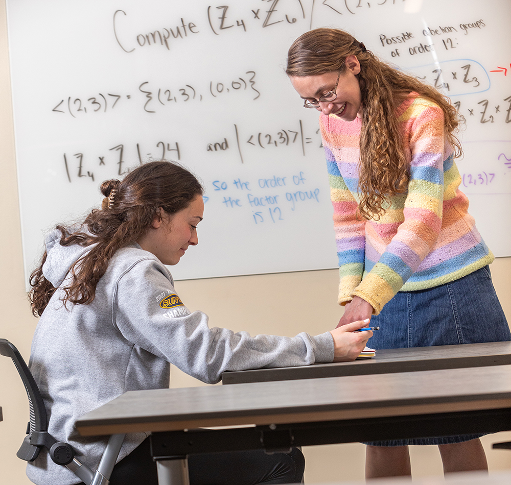 Math teacher working with a student